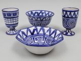 several blue and white bowls and cups on a white surface