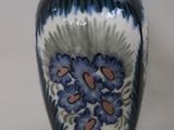 a blue and white vase with flowers on it
