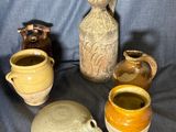 five different types of vases sitting on a blue cloth