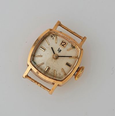 a gold watch with roman numerals on the face
