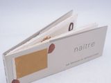 a close up of a book opened on a white surface