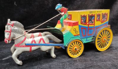 a toy horse pulling a carriage with a man on it