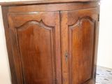 a small wooden cabinet with a door on top of it