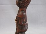 an old wooden statue of a woman with a hat on her head