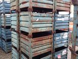 many wooden crates stacked on top of each other in the dirt