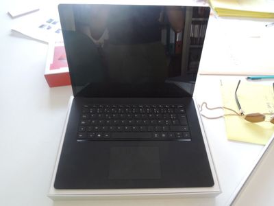 a laptop computer sitting on top of a white desk