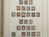 an open book with stamps on it on a table