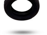 a tire that is flying in the air on a white background