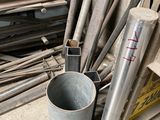 many different types of metal pipes and pipes in a pile