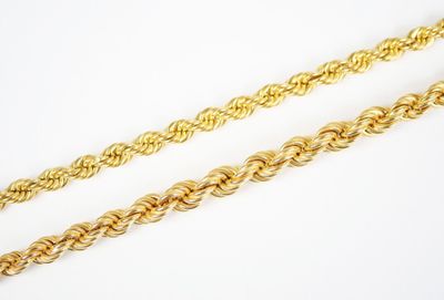 a pair of gold chains on a white background
