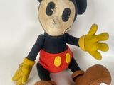 disney mickey mouse plush toy sitting on a white surface