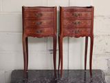 two small wooden chests on top of a marble table