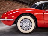 an image of a red and white car parked in a garage