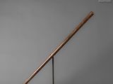 an old baseball bat sitting on top of a metal stand