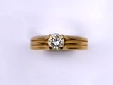 a close up of a gold ring with a diamond on it