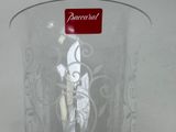 a glass vase with a figurine of a man in a top hat on it
