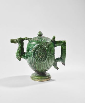 green ceramic teapot with handles and handles on a white background
