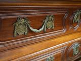 an image of a dresser with brass handles on it