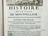 an old book with a picture of a castle in the background