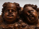 two statues of two children that are sitting on top of each other
