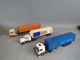 several toy trucks are lined up on a table next to a mouse
