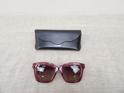 sunglasses and a case on a table with a white background