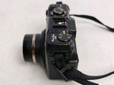 a black camera with a strap attached to it