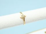 a close up of a gold ring on a white napkin