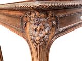 a wooden table with carvings on the top of it