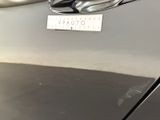 a close up of a car door handle with a sticker on it