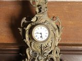 a clock that is sitting on a shelf in a room