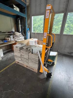 a picture of a forklift in a warehouse with stacks of wood