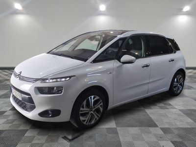 the white citrole is parked on a checkered tile floor