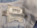 blue and white striped shirt with a label on the chest