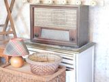 a small table with a basket and a radio on it