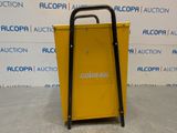 a yellow cart sitting on top of a cement floor next to a wall