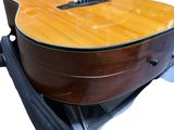 a guitar sitting on top of a suitcase on a white background