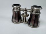 an antique pair of silver plated binoculars on a white background
