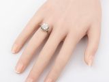an image of a woman ' s hand with a diamond ring on it