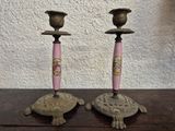 two candles that are sitting on top of a table