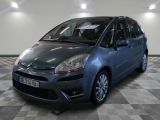 a picture of a small blue car parked in a garage