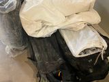 a pile of luggage sitting on the floor next to a wall