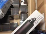 a box with a bottle in it next to a box of other items