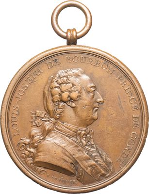 une vieille médaille en bronze sur laquelle figure le portrait d'un homme