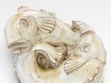 a small white object with a fish on top of it