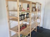 a shelf with bottles of wine on it in a room