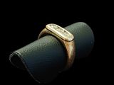 a close up of a gold ring on a black surface