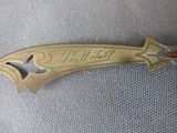an old brass plate with the name of a person on it
