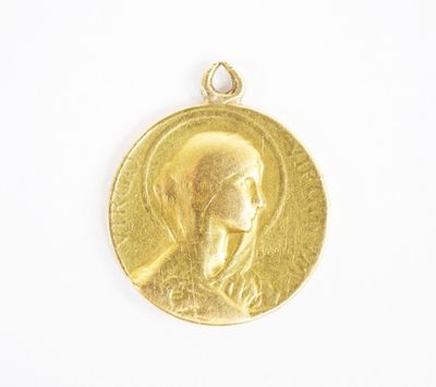 a close up of a gold medal on a white surface