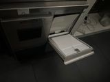 a small refrigerator in the middle of a kitchen floor